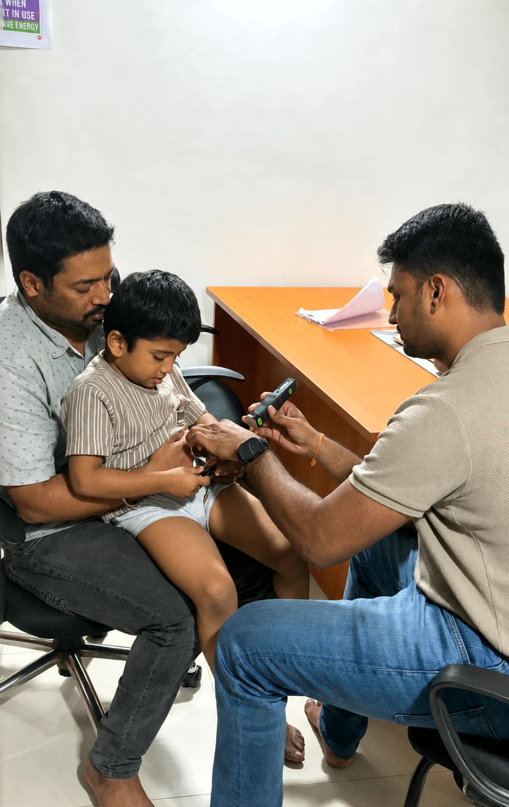 DARC therapist explaining laser therapy support while a parent stays beside the child