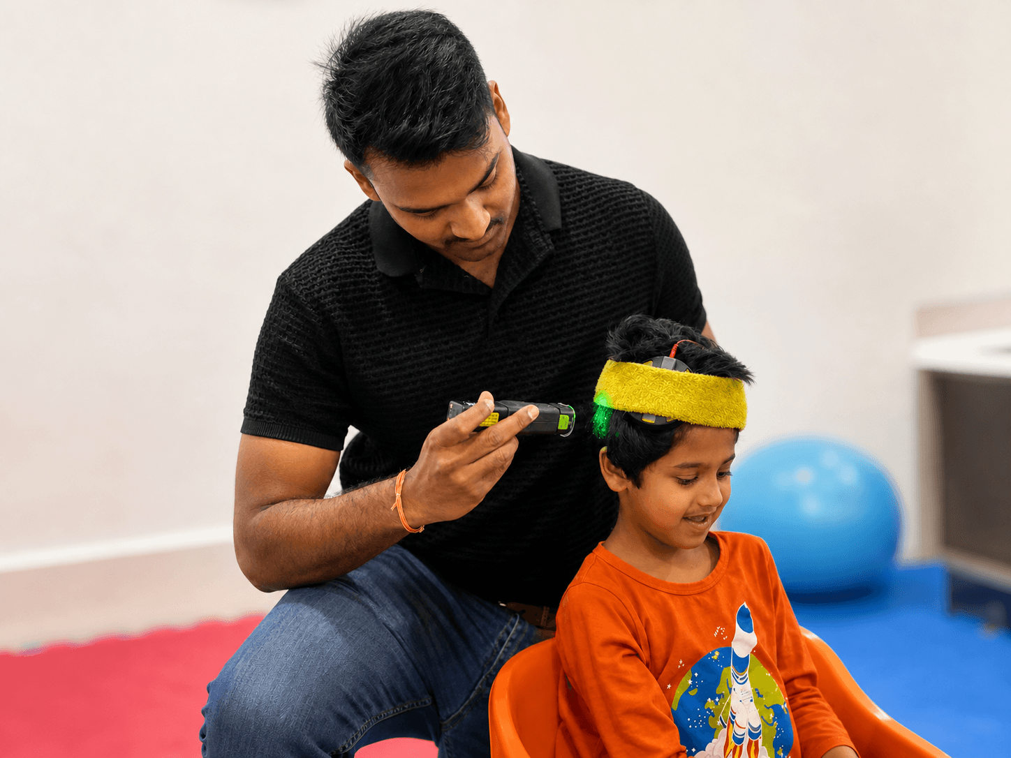Dr. Aaditya providing a supervised photobiomodulation session for a child