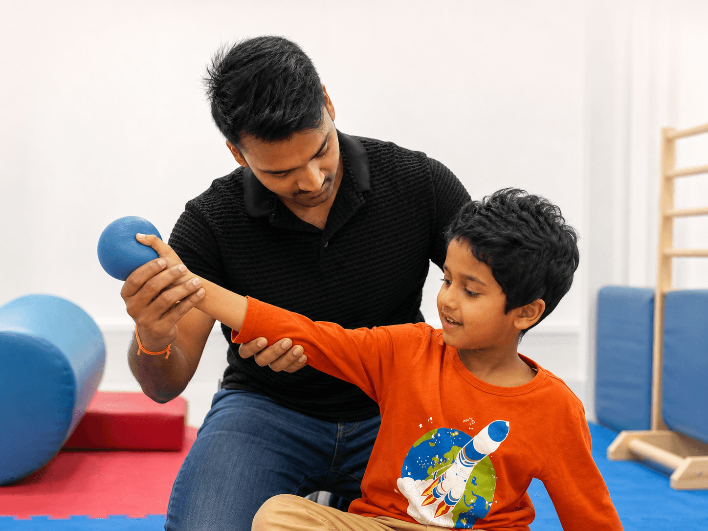 Dr. Aaditya guiding a child through hands-on sensory-motor work