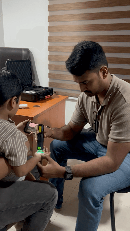 Parent receiving a detailed explanation of a photobiomodulation device and protocol